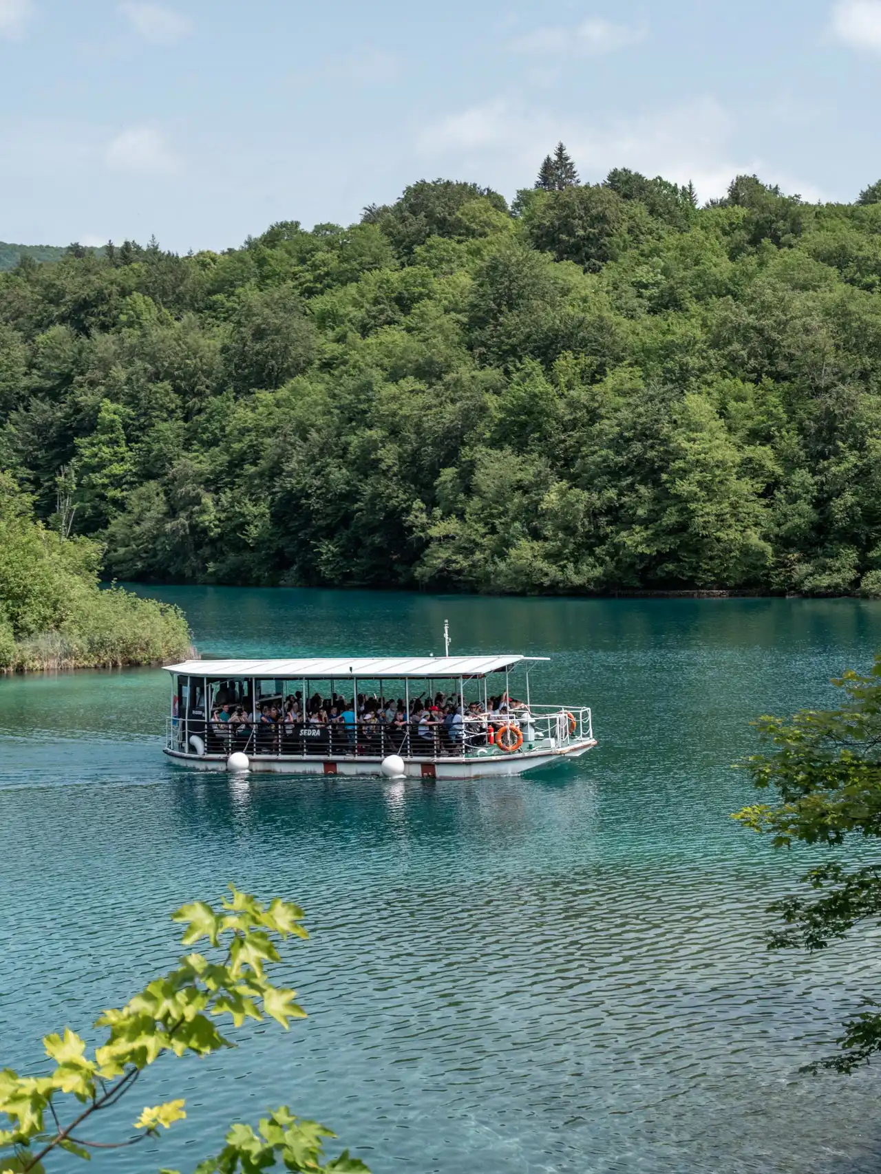Petit bateau blanc électrique qui sert de navette aux Lacs de Plitvice en Croatie